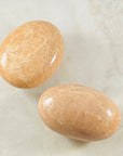 Peach Moonstone palm stone by Sarah Belle, for strengthening your meditation and relaxation.