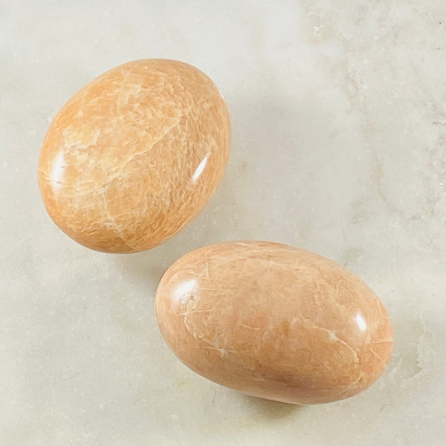 Peach Moonstone palm stone by Sarah Belle, for strengthening your meditation and relaxation.