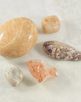 Peach Moonstone palm stone for healing energy and emotional balance.