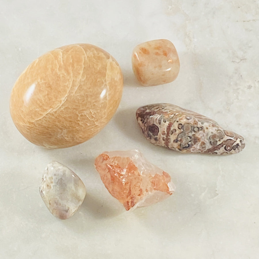 Peach Moonstone palm stone for healing energy and emotional balance.